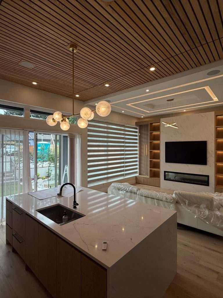 Ethereal Glow quartz waterfall island with an undermount sink in an open-plan Burnaby kitchen.